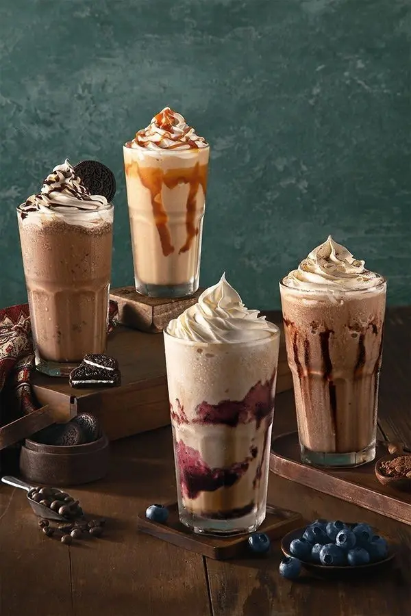 Four tall glasses of creamy milkshakes and cool drinks served at the best bakery in Wayanad